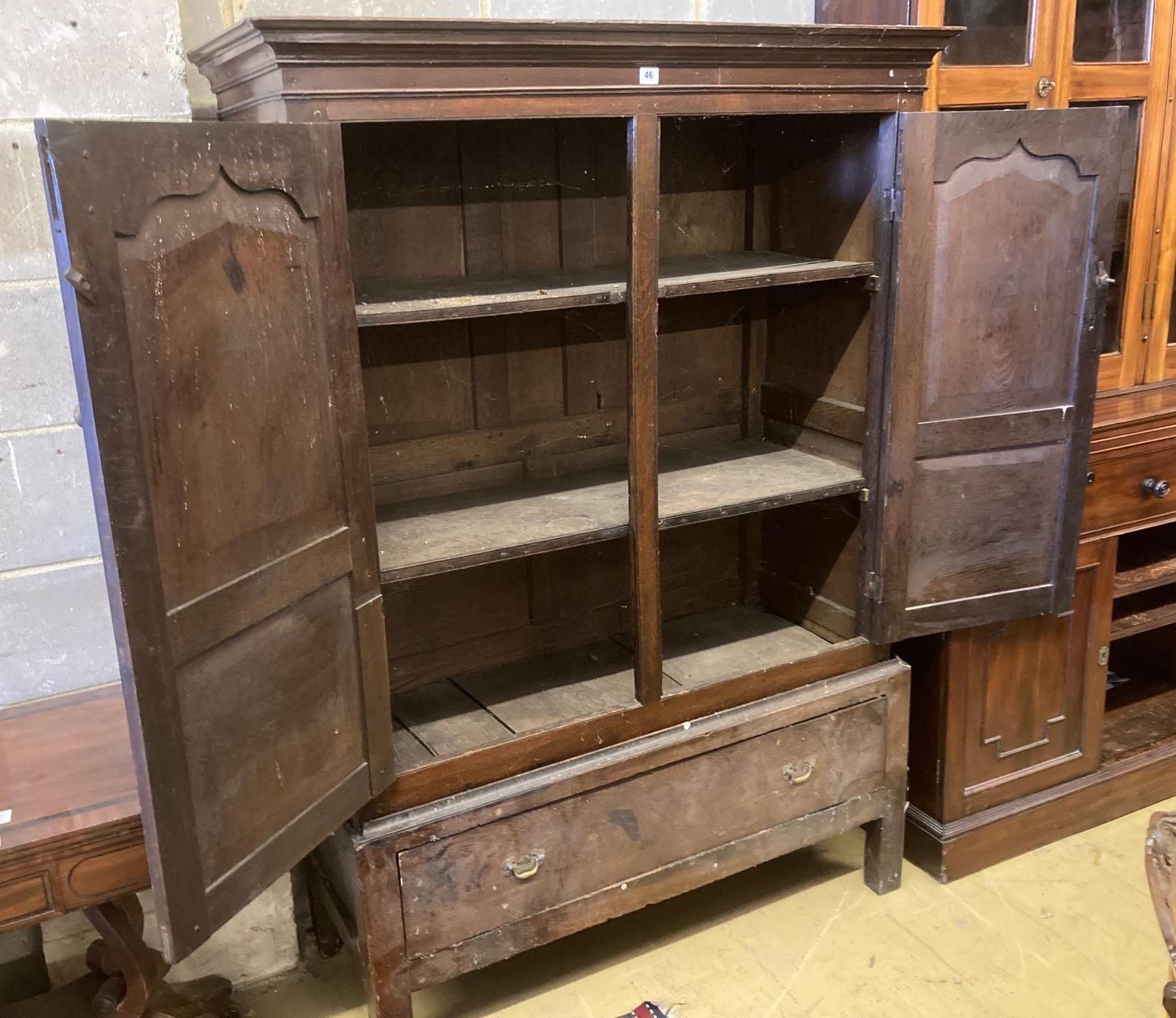 An 18th century oak press cupboard with base drawer, width 120cm height 169cm